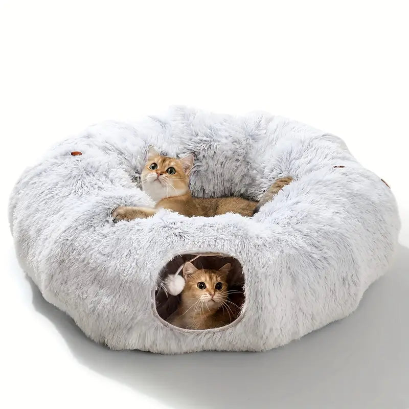 Two cats peeking out from a round gray cat tunnel bed with a plush white interior.