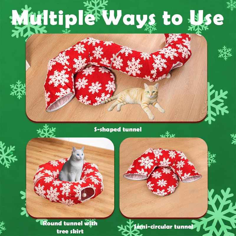 Red and white snowflake-patterned tunnel with a cat on a wooden surface, surrounded by green snowflake decorations.
