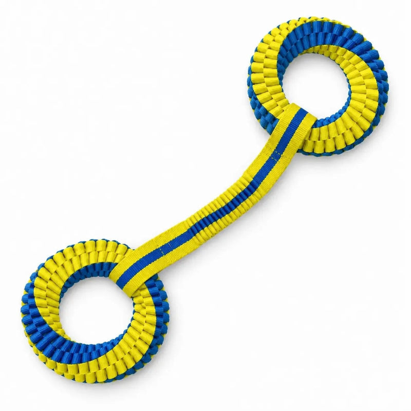 A blue and yellow woven dog toy with two ring ends connected by a ribbed strap, shown on a plain white background.